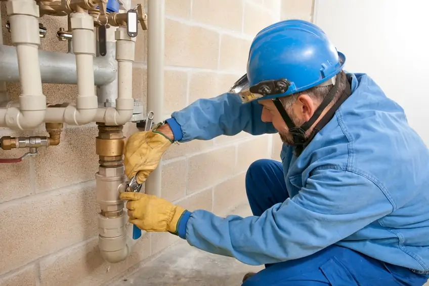 Expert plumber inspecting commercial pipes.